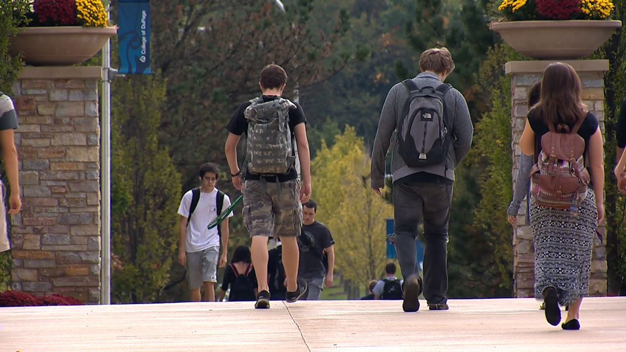 Modal Image Opens to lightbox video - Students walking on campus