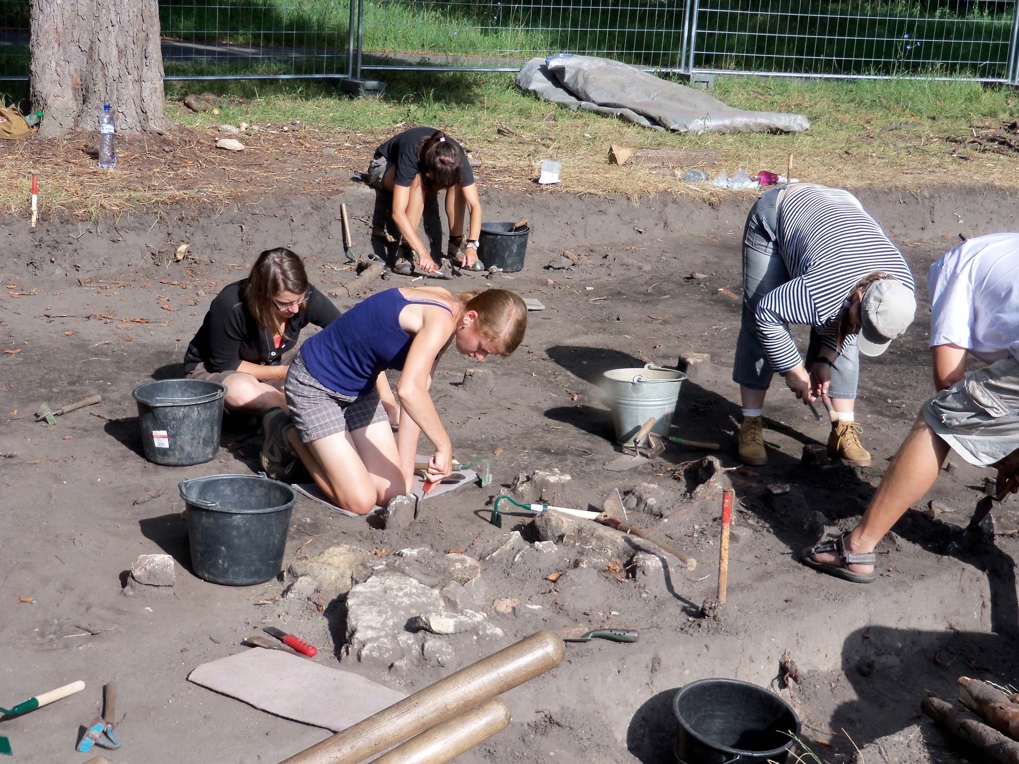 students digging at grave site in the czech republic