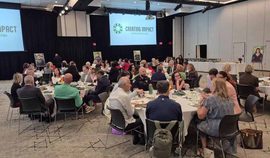Event guests sitting and talking at tables in SRC.