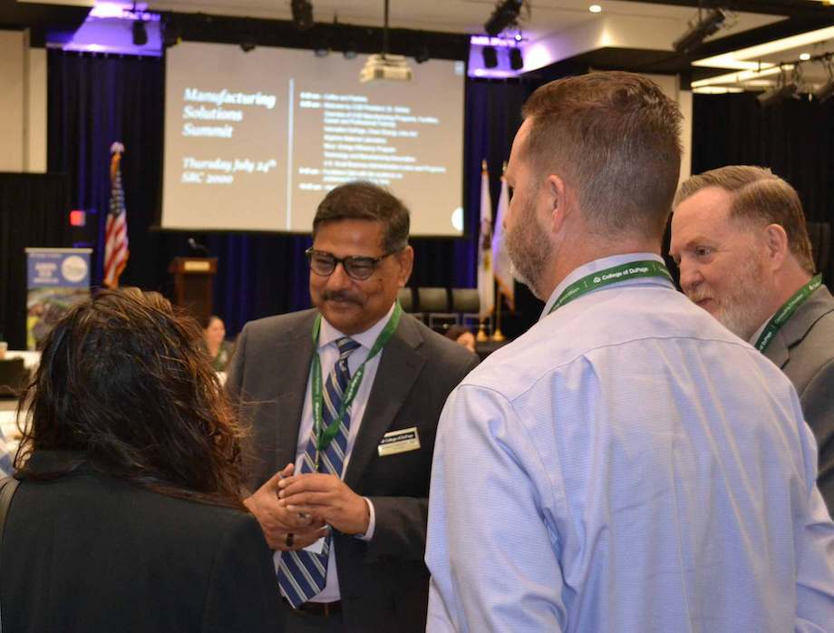 Dr. Muddassir Siddiqu and Dr. Joe Cassidy talk to two attendees