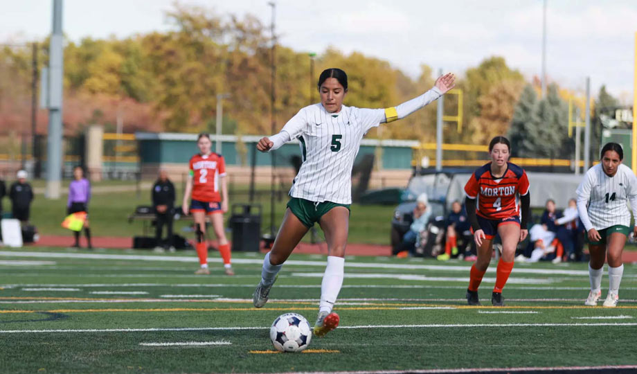 Soccer player kicking ball.