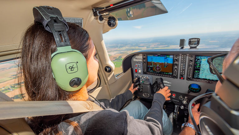 Modal Image Opens to lightbox video-female student piloting an airplane in the air